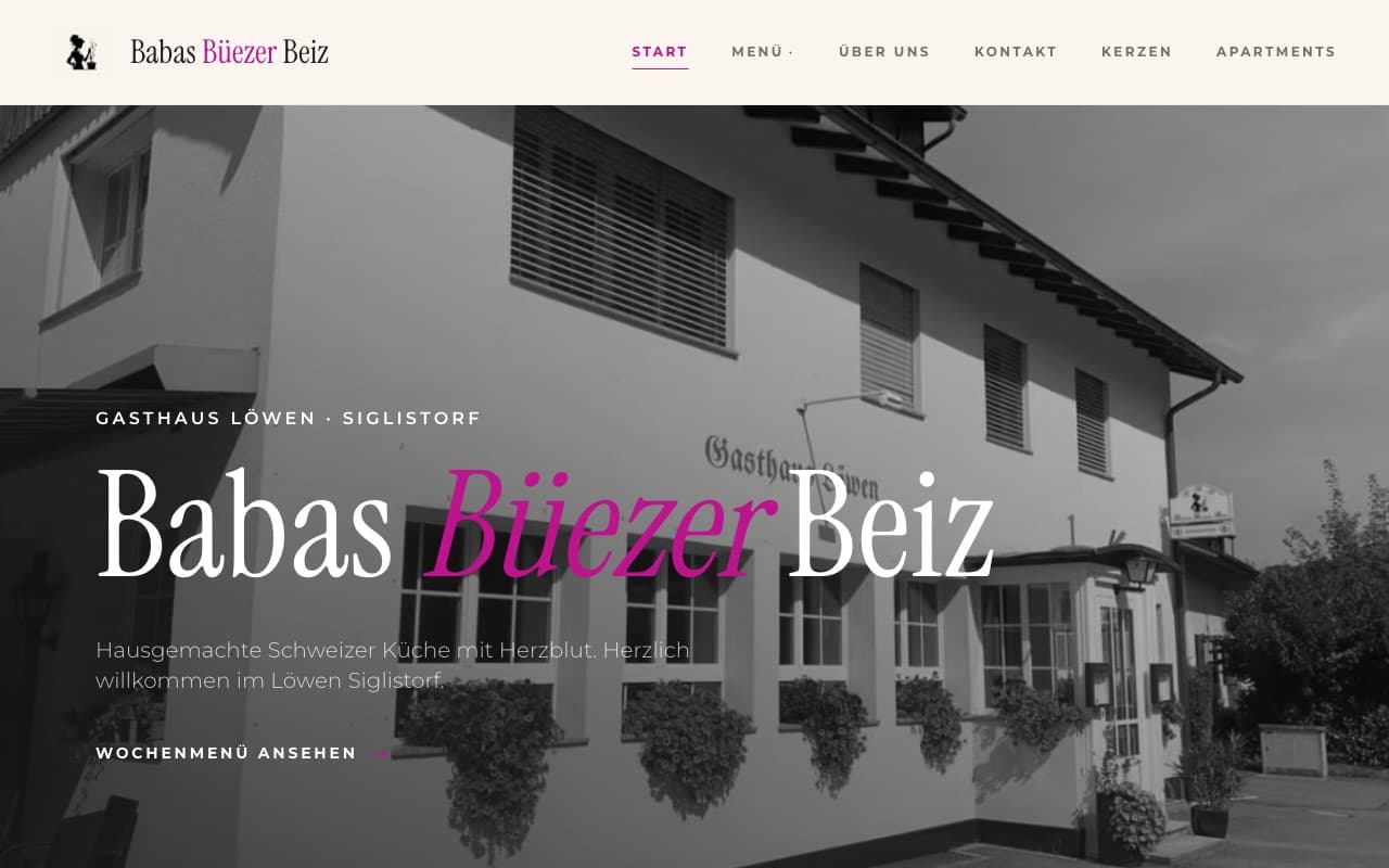 Homepage of Babas Büezer Beiz, the Swiss restaurant site described in this post. A black-and-white photo of the Gasthaus Löwen building sits behind the wordmark 'Babas Büezer Beiz', with 'Büezer' set in italic pink, above a German tagline and a 'Wochenmenü ansehen' button.